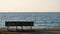 A lone bench at the water`s edge on a beautiful