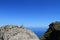 Lone big stone on a mountain summit on blue sky background, photo of nature