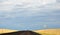 Lone biker on an empty rural road with `Do Not Pass` sign in the foreground