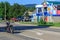 A lone biker rides a motorcycle on the road on a summer day in the village of Kamennomostsky