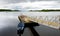 Lone boat tied to small pier on Lough Leane, the largest and northernmost of the lakes of Killarney National Park, County Kerry,
