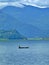 Lone boatman on gorgeous, Fewa lake, mountain backdrop Pokhara, Nepal,