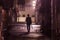 Lone businessman walks home late at night after rain