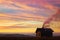 lone cabin with chimney smoke, surrounded by sunset colors