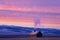 lone cabin with chimney smoke, surrounded by sunset colors