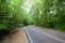 A Lone Car Drives Down A Winding Road