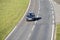 Lone car driving on a stretch of duel carriageway