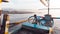 a lone child playing on a boat on the beach in the afternoon