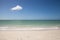 Lone cloud in a Blue sky over white sand of Tigertail Beach