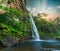 Lone creek waterfall and pond below during colorful sunset in Sabie