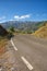 Lone cyclist, heading towards a bend in the road. Andalucia, Spain.