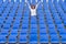 Lone female fan or spectator sitting cheering