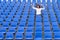 Lone female fan or spectator sitting cheering