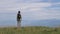 A lone female hiker on a mountain top