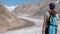 A lone female hiker treks next to the famous aletsch glacier