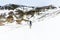 Lone female traveler hiking in the snow with a backpack. Winter snowy mountains in Pyrenees