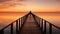 Lone figure standing on a long pier wooden at sunset