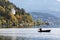 A lone fisherman in a motor boat on lake Millstatt. Austria