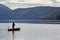 A lone fisherman in a motor boat on the lake Millstatt. Austria