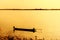 A lone fisherman moves out on a lake.