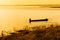 A lone fisherman moves out on a lake