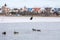 A lone fisherman risks his life, he sits dangerously on the edge of thin melting ice and fishes.