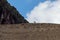 Lone goat standing on a mountain ridge, the brilliant blue sky providing a breathtaking backdrop