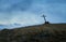 Lone grave in the steppe, the old wooden cross on the grave. The