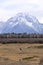 Lone, grazing horse in Teton landscape is solitary Western tranquility