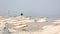 Lone guitarist playing on rocky landscape from above