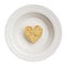 Lone heart-shaped cookie in a plate