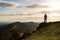 A lone hiker looking out across the ridge of the Malvern Hills on a sunny winters afternoon. Malvern Hills, England