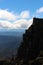 Lone hiker on the the peak of Cradle mountain