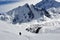 A lone hiker on the Tilicho Lake trek on the Annapurna circuit, walking through snow, surrounded by snow covered Peaks, Himalayas,