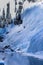 A lone ice climber scales the side of a frozen mountain