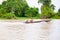 Lone man in dugout on Mekong.