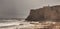 Lone man stands at a vista as Fog drifts in over the ocean at Cr