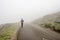 Lone man walking through the white fog