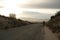 Lone man walks on empty highway.