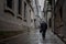 Lone Old Man Walking up Quiet Spanish Street in the Rain