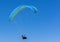 Lone Paraglider in mid-air with blue sky