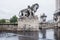 Lone Paris rental bicycle stands at the base of a statue on the