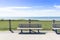 Lone park bench in the sunlight at a michigan beach