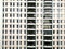 A lone person stands on the balcony of a large hotel