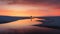 a lone person stands on the beach at sunset