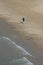 A lone person walks along the Lake Michigan shoreline in Chicago, Illinois