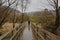 Lone person on a wooden walkway through a rainy wicklow mountains landscape in early spring