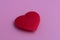 A lone, red, heart made of fabri
