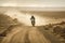 A Lone Rider on a Motorcycle Speeding through a Challenging Desert Terrain Kicking up Dirt and Gravel in the Air