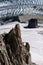 Lone rock climber on top of pinnacle overlooking glacier